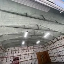 A large warehouse filled with lots of shelves and boxes.